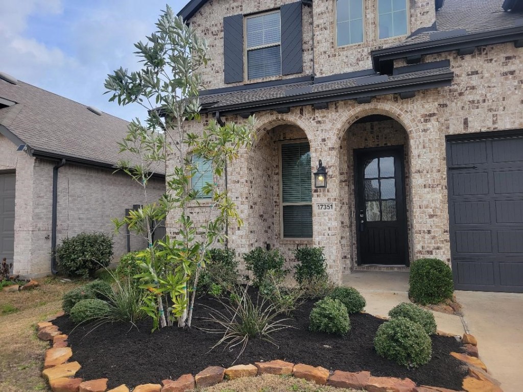 17351 Merigold Hts Drive Conroe, TX 77302 - Photo 2 of 49 a front view of a house with plants