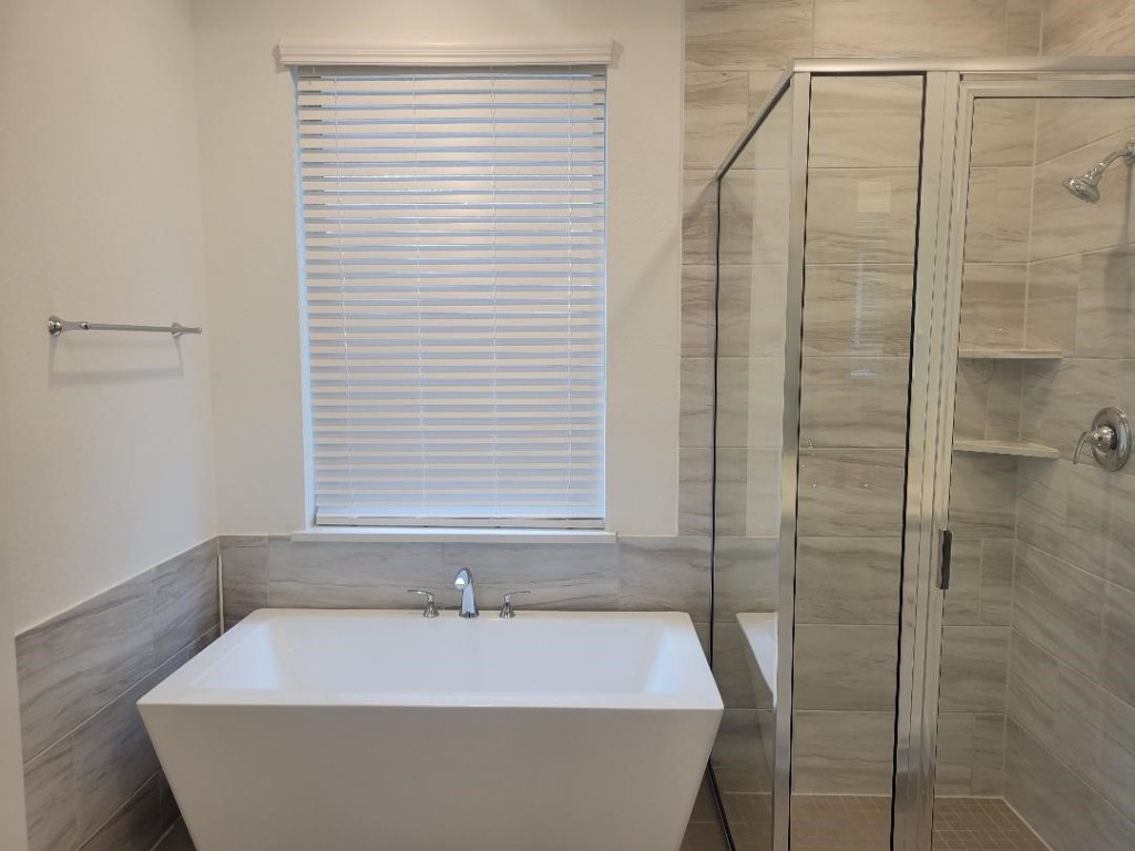 17351 Merigold Hts Drive Conroe, TX 77302 - Photo 21 of 49 a bathroom with a white bath tub and a shower
