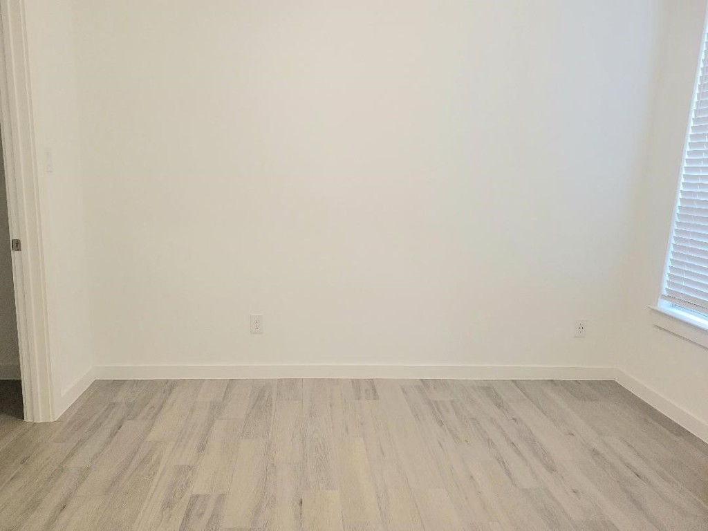 17351 Merigold Hts Drive Conroe, TX 77302 - Photo 26 of 49 a view of an empty room with wooden floor and a window