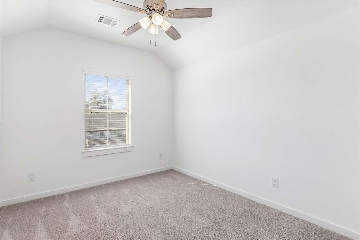 17351 Merigold Hts Drive Conroe, TX 77302 - Photo 29 of 49 an empty room with a window and a fan
