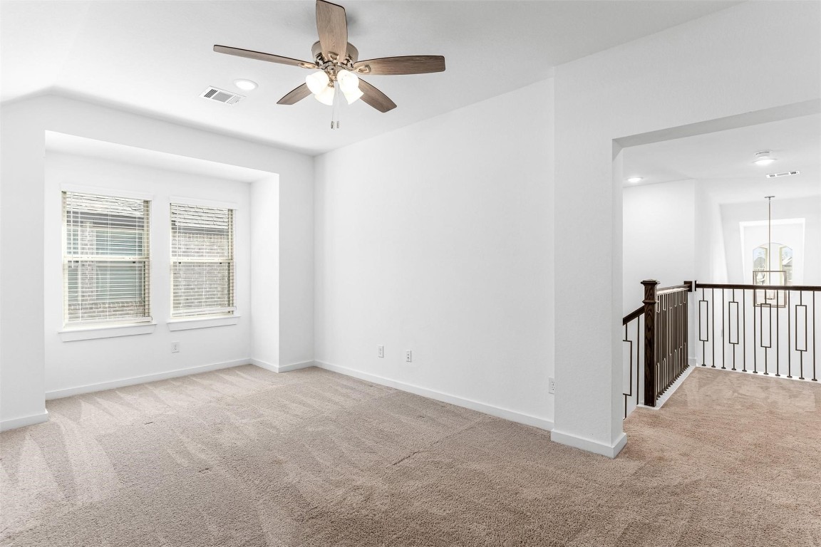 17351 Merigold Hts Drive Conroe, TX 77302 - Photo 34 of 49 an empty room with chandelier fan