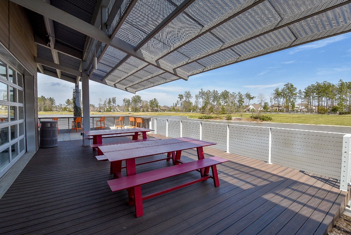 17351 Merigold Hts Drive Conroe, TX 77302 - Photo 46 of 49 a balcony with wooden benches and outdoor seating