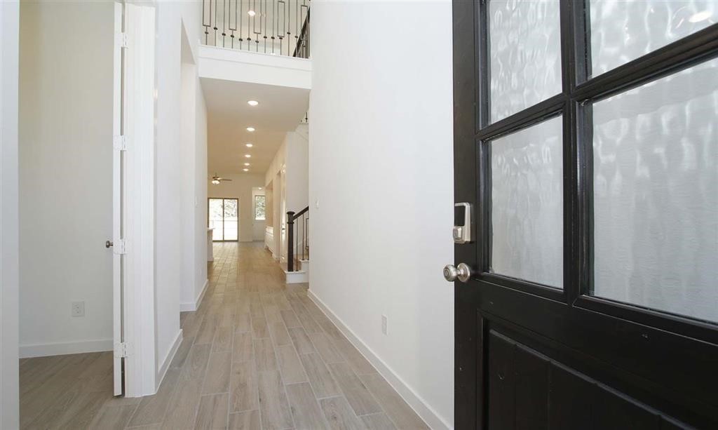 17351 Merigold Hts Drive Conroe, TX 77302 - Photo 5 of 49 a view of a hallway with wooden floor and staircase