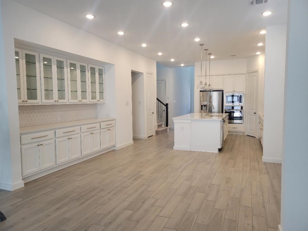 17351 Merigold Hts Drive Conroe, TX 77302 - Photo 7 of 49 a view of a kitchen with furniture and wooden floor