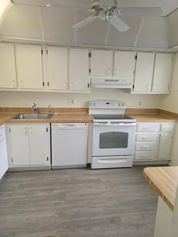 a kitchen with cabinets a sink and appliances