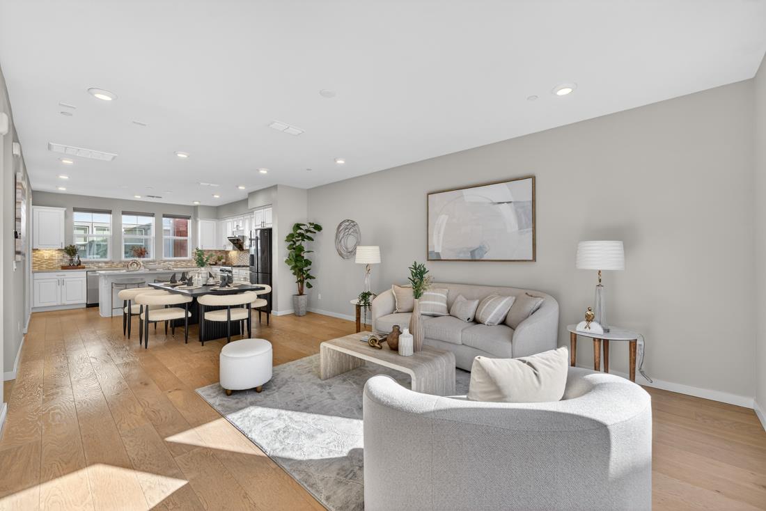 a living room with furniture and view of kitchen