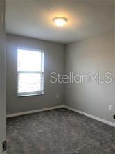250 Evertree Loop Sanford, FL 32771 - Photo 13 of 19 an empty room with a window