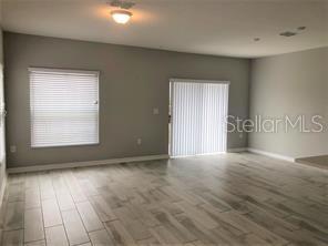 250 Evertree Loop Sanford, FL 32771 - Photo 2 of 19 an empty room with wooden floor and windows