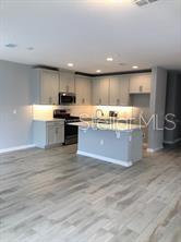 250 Evertree Loop Sanford, FL 32771 - Photo 3 of 19 a view of kitchen with stainless steel appliances granite countertop a stove and a sink