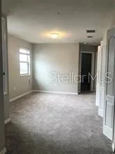an empty room with windows and closet