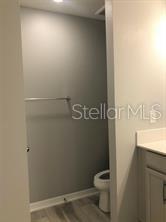 250 Evertree Loop Sanford, FL 32771 - Photo 9 of 19 a bathroom with a granite countertop toilet and a sink