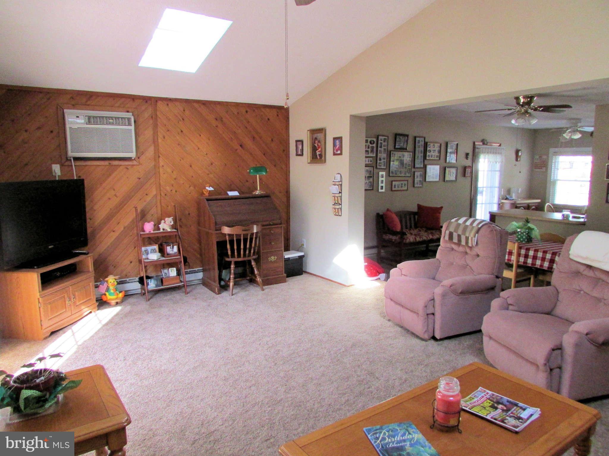 6915 Pinecrest Road Baltimore, MD 21228 - Photo 11 of 30 a living room with furniture and a flat screen tv