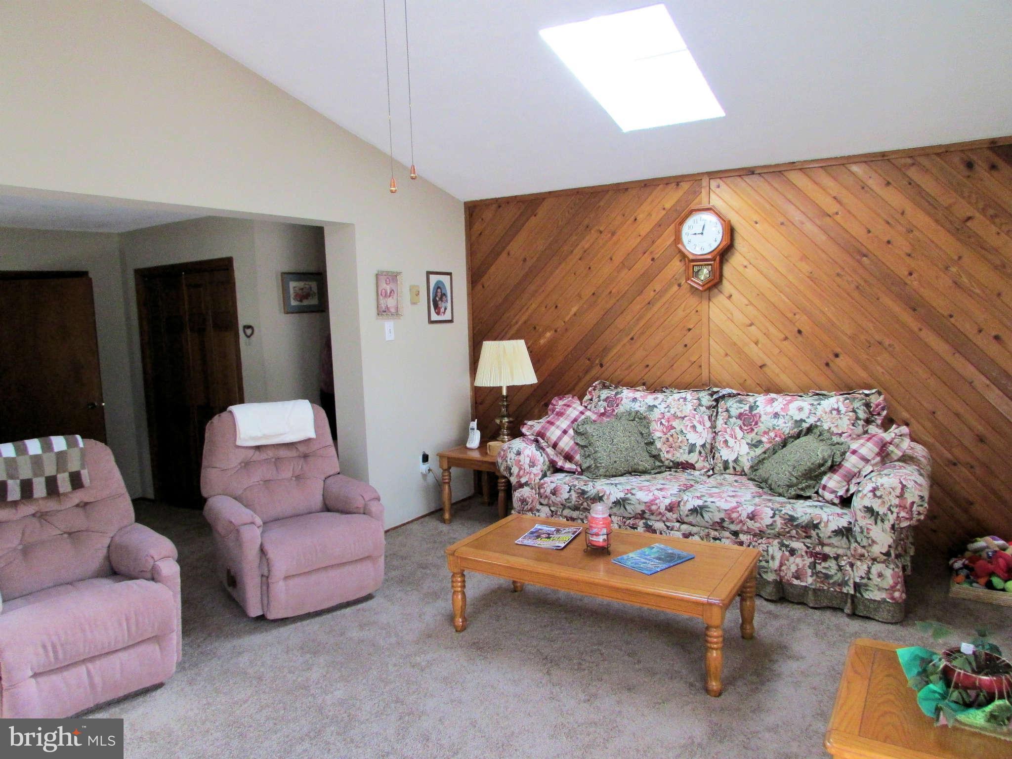 6915 Pinecrest Road Baltimore, MD 21228 - Photo 12 of 30 a bedroom with a bed and a couch