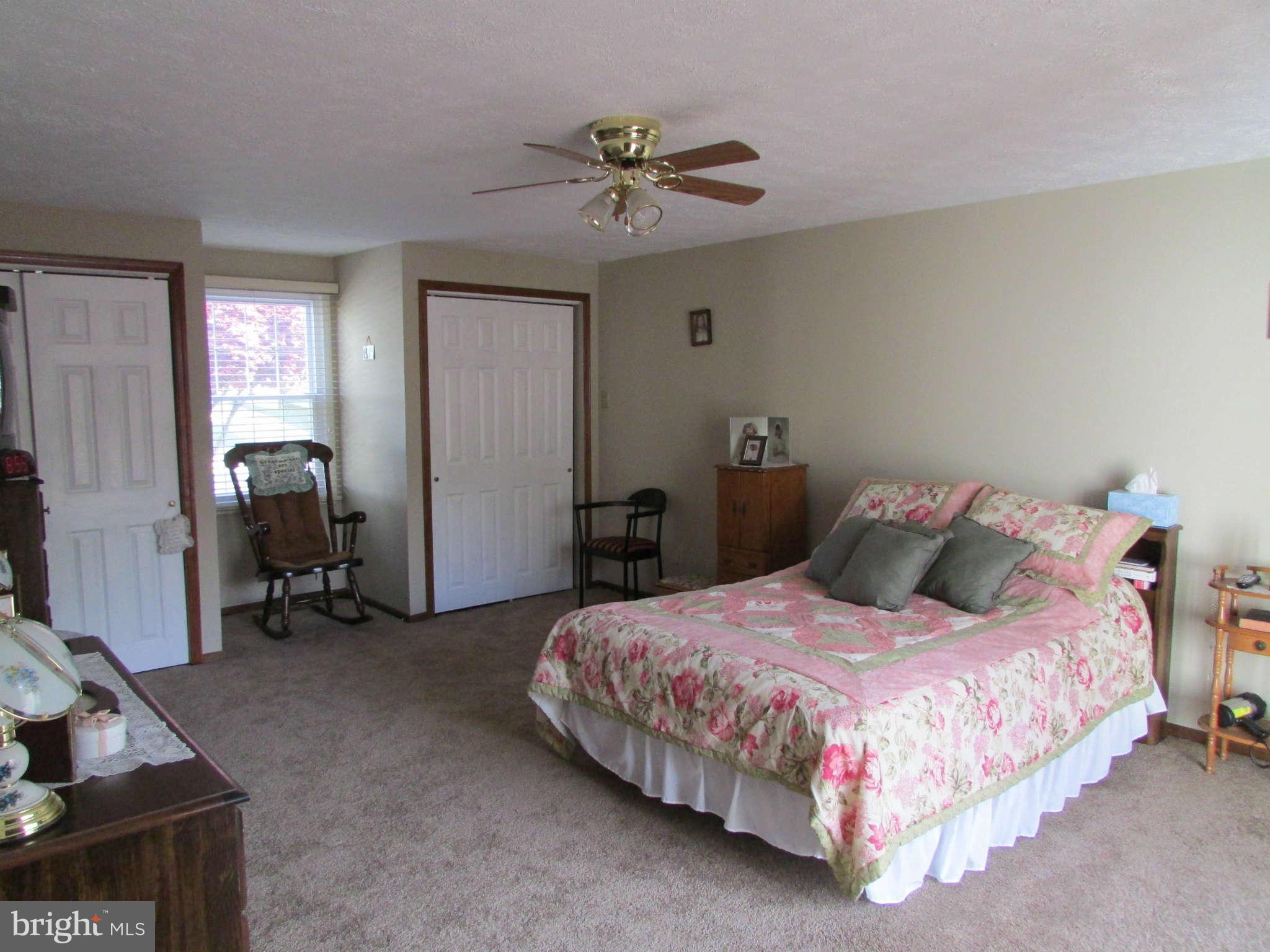 6915 Pinecrest Road Baltimore, MD 21228 - Photo 13 of 30 a bedroom with a bed and a chandelier