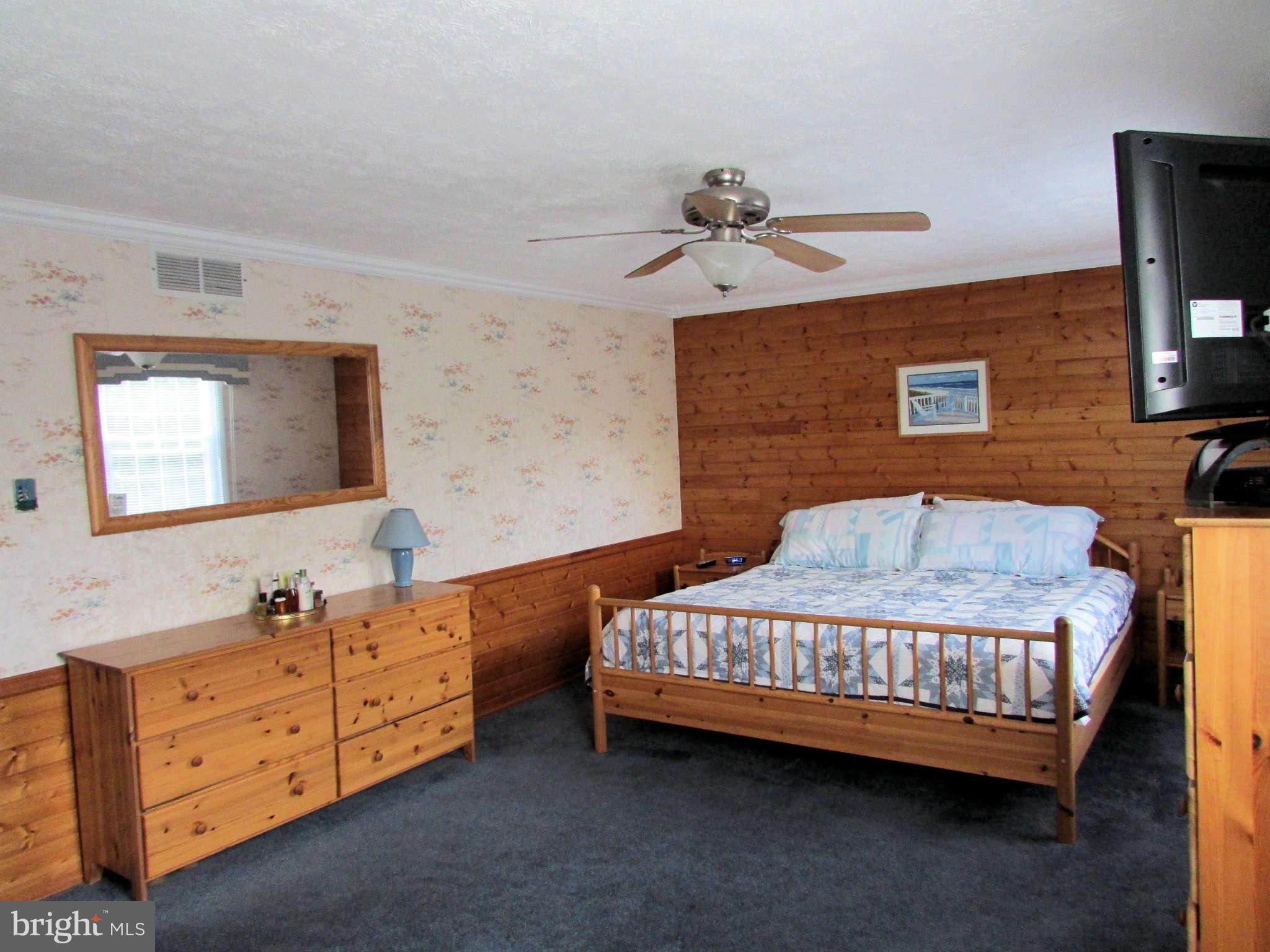 6915 Pinecrest Road Baltimore, MD 21228 - Photo 15 of 30 a bedroom with a bed and a dresser in it