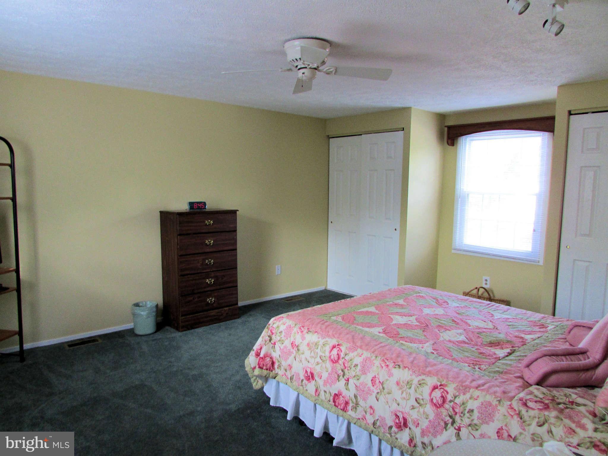 6915 Pinecrest Road Baltimore, MD 21228 - Photo 17 of 30 a bedroom with a bed and a window