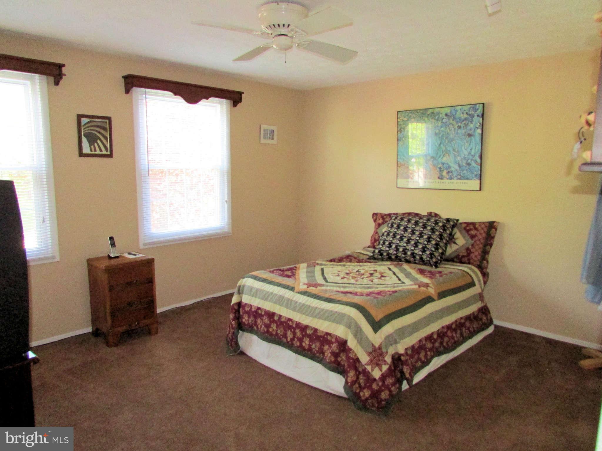 6915 Pinecrest Road Baltimore, MD 21228 - Photo 20 of 30 a bed sitting in a bedroom next to a window