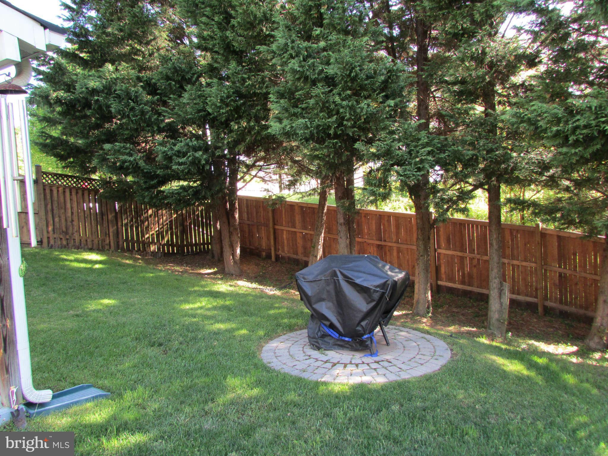 6915 Pinecrest Road Baltimore, MD 21228 - Photo 29 of 30 a view of a backyard with wooden fence and a large tree