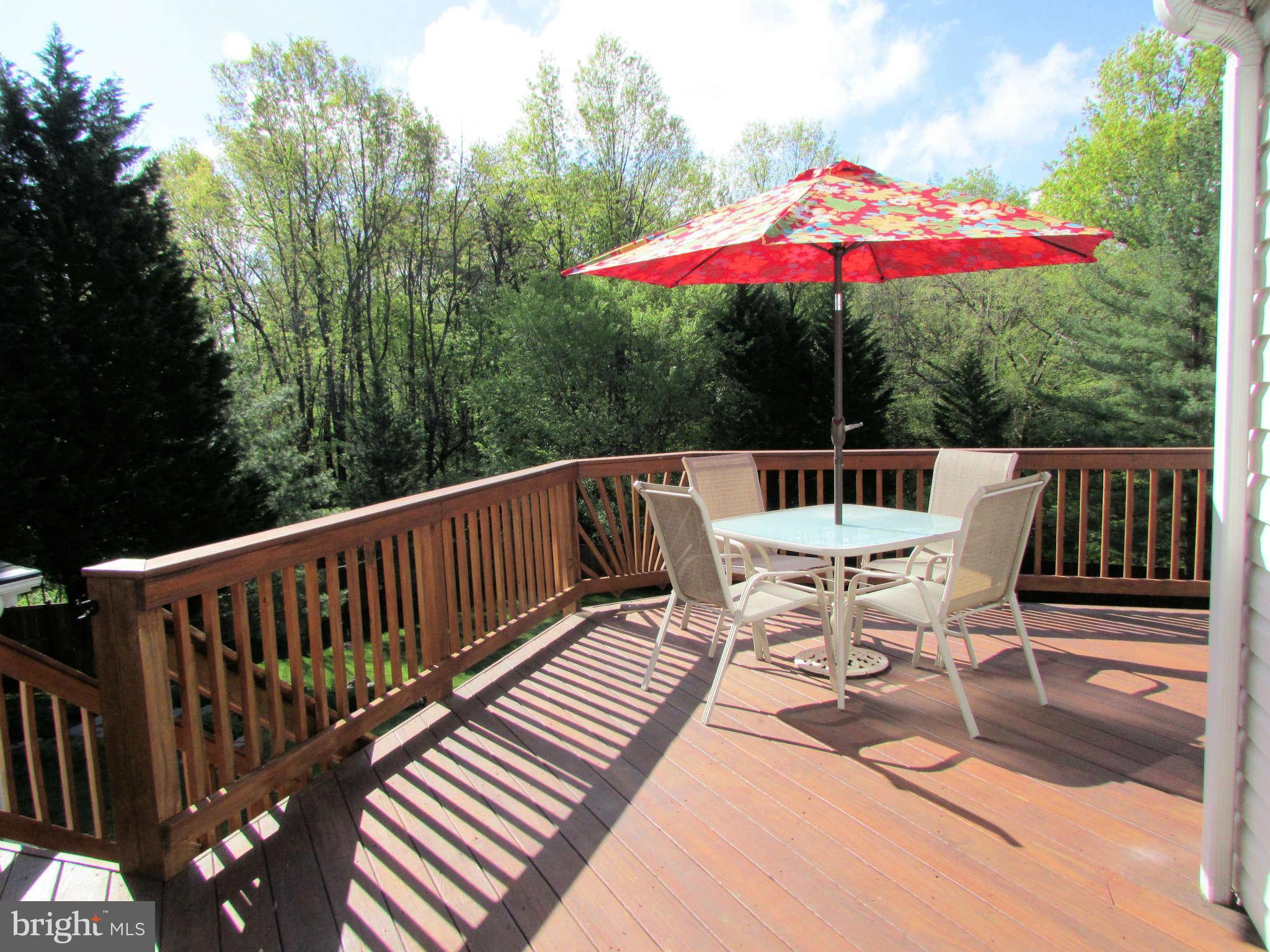 6915 Pinecrest Road Baltimore, MD 21228 - Photo 4 of 30 a view of balcony with wooden floor and umbrella