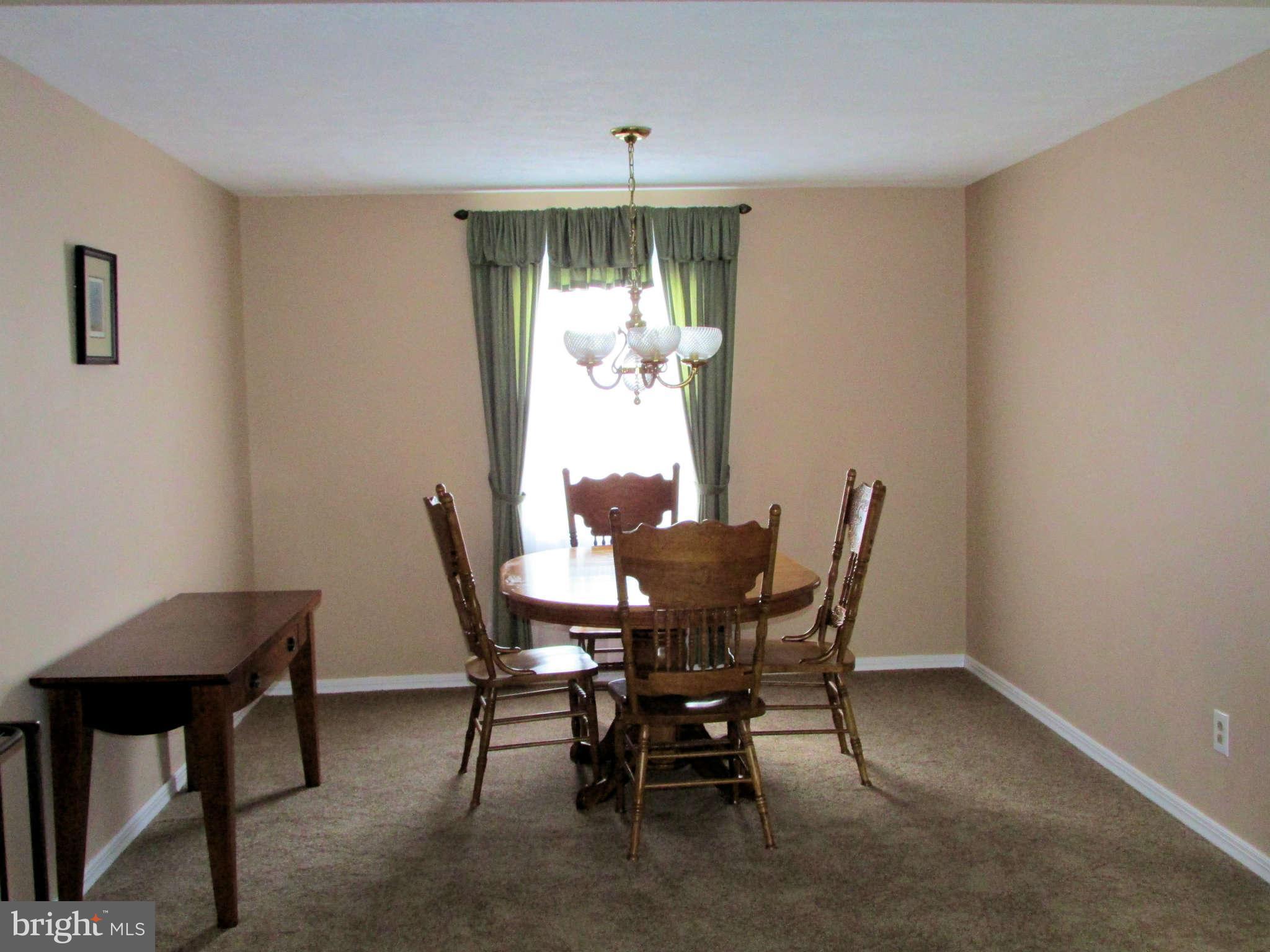 6915 Pinecrest Road Baltimore, MD 21228 - Photo 6 of 30 a dining room with furniture and window