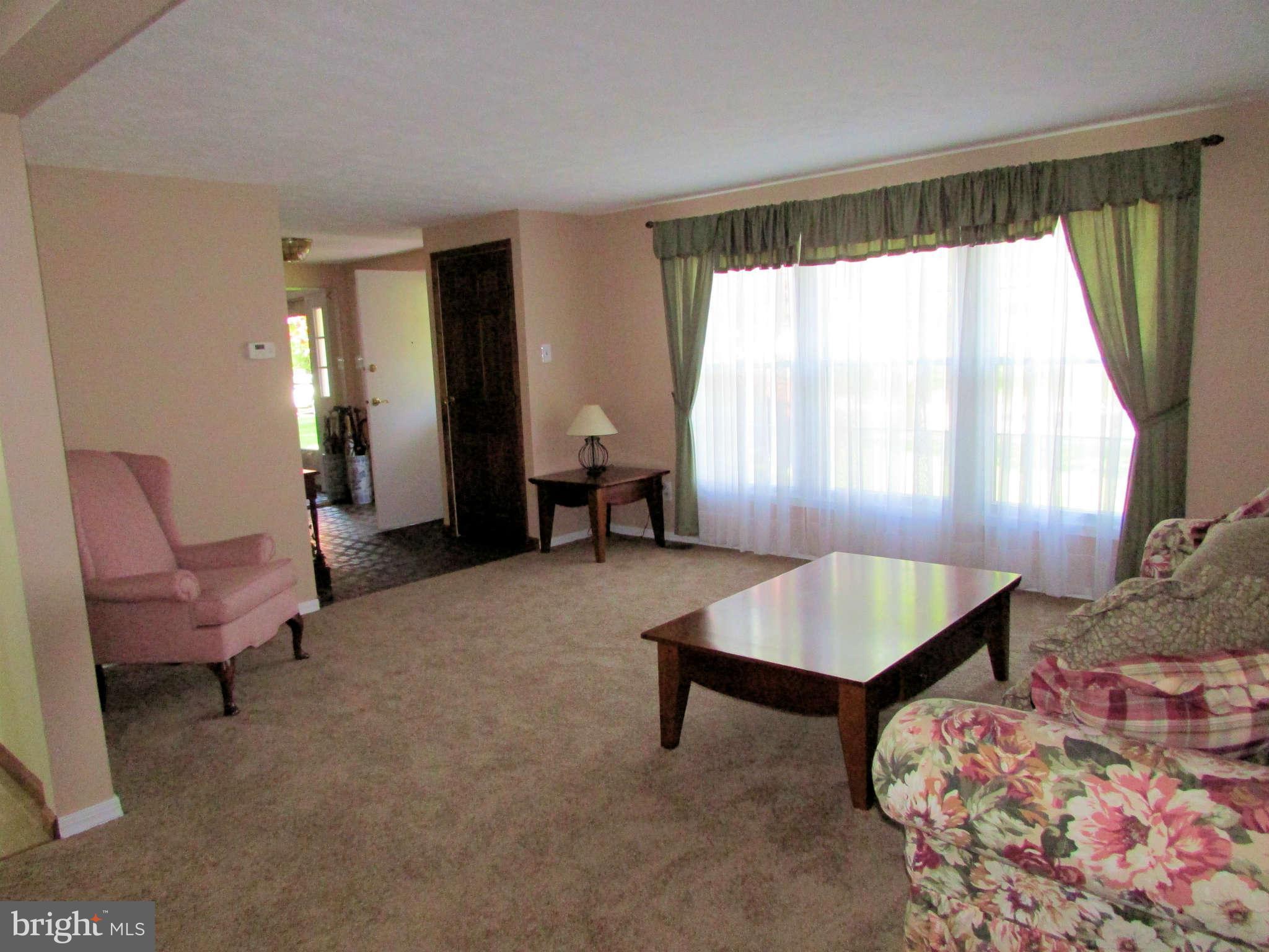 6915 Pinecrest Road Baltimore, MD 21228 - Photo 7 of 30 a living room with furniture and a window