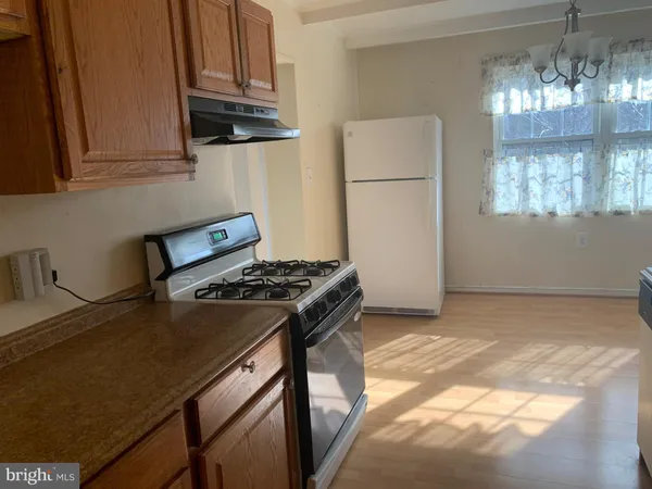 a kitchen with stainless steel appliances granite countertop a stove a refrigerator and a microwave