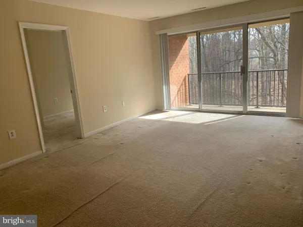 a view of empty room with floor to ceiling window