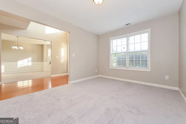 an empty room with a empty space and windows