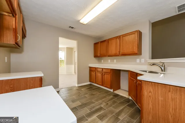 a bedroom with a large bed and cabinets