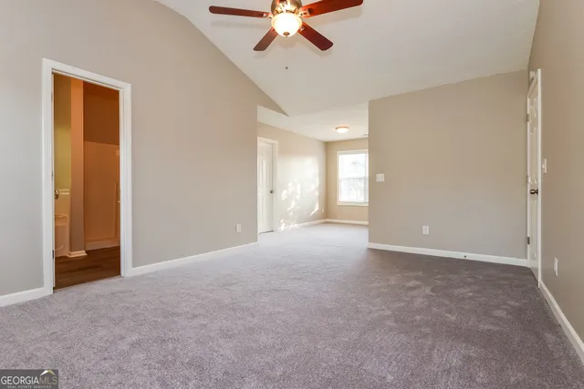 a view of an empty room with a ceiling fan