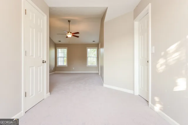 a view of a chandelier fan and entryway