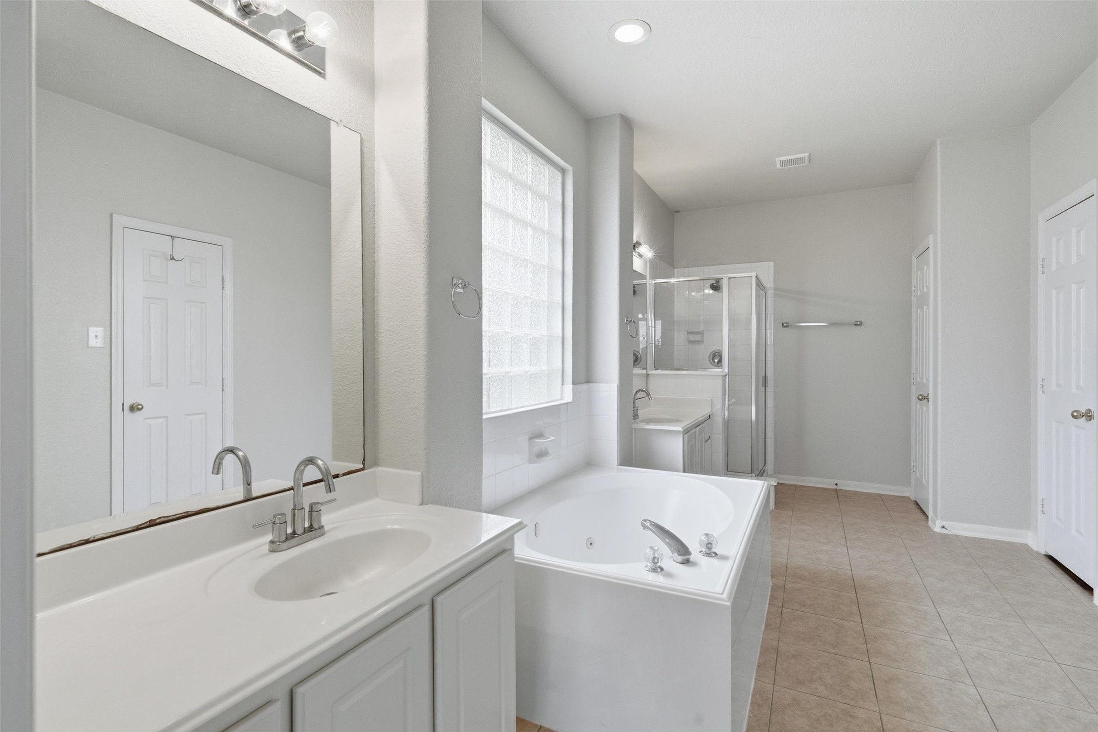 4607 Sebastopol Drive Pearland, TX 77584 - Photo 14 of 26 a bathroom with a sink a toilet and a large mirror