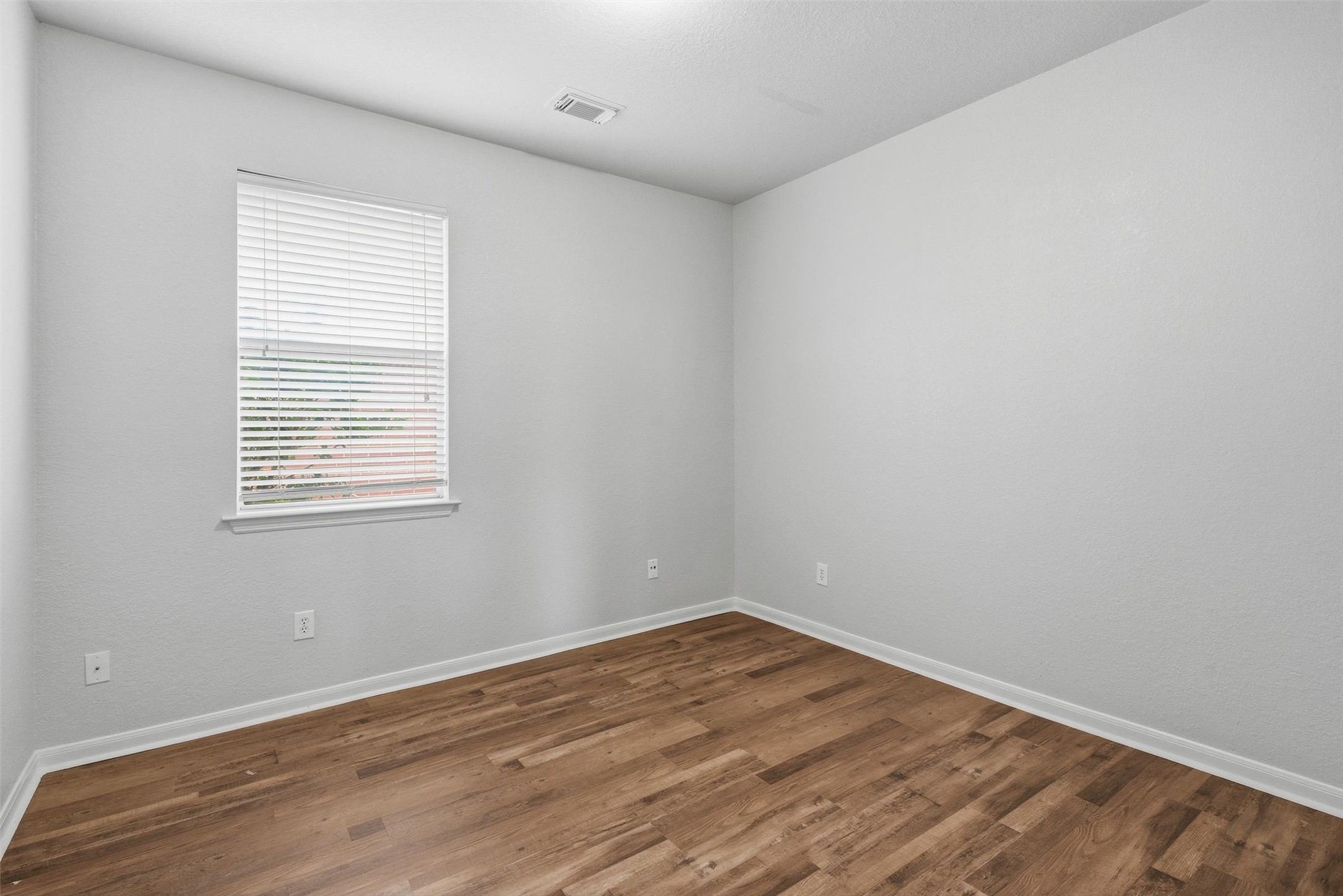4607 Sebastopol Drive Pearland, TX 77584 - Photo 18 of 26 wooden floor in an empty room with a window