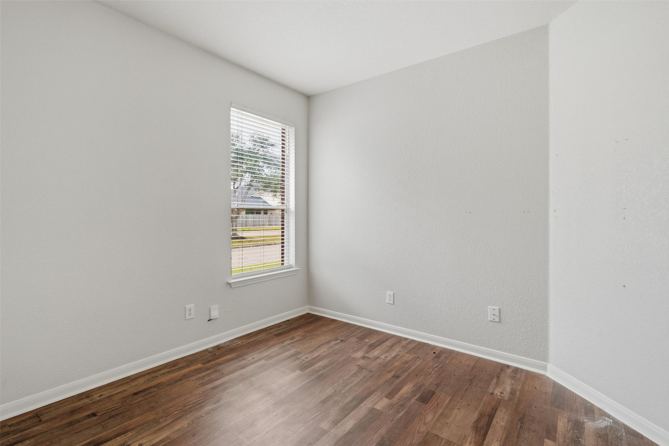 4607 Sebastopol Drive Pearland, TX 77584 - Photo 19 of 26 a view of an empty room with wooden floor and a window