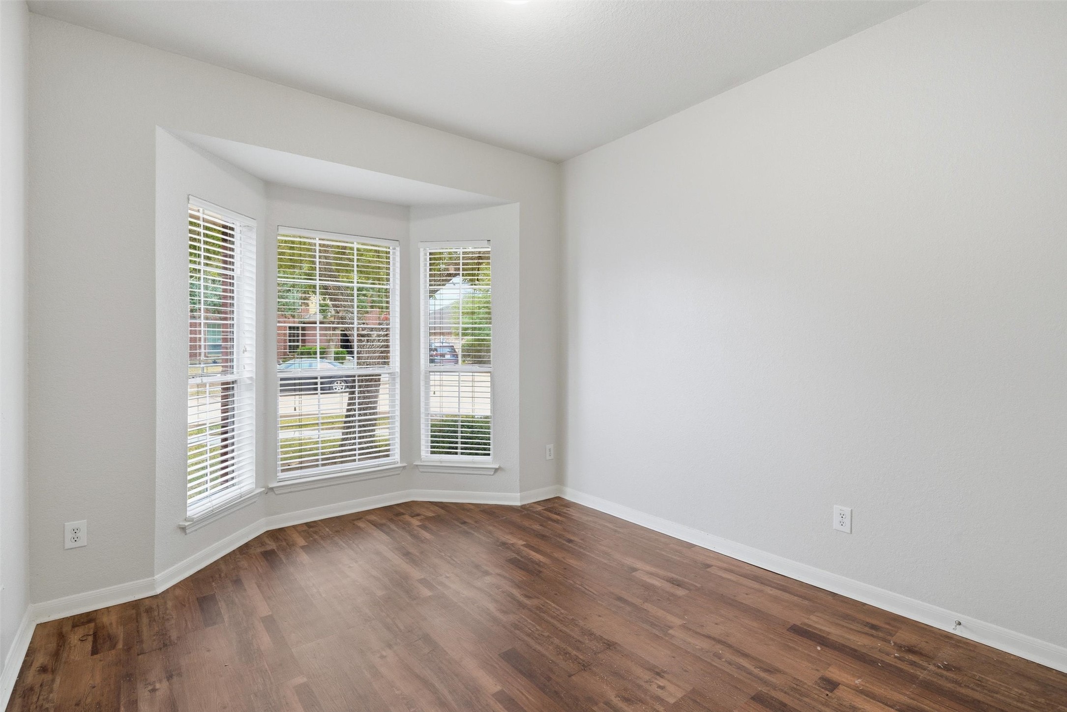 4607 Sebastopol Drive Pearland, TX 77584 - Photo 21 of 26 an empty room with wooden floor and windows