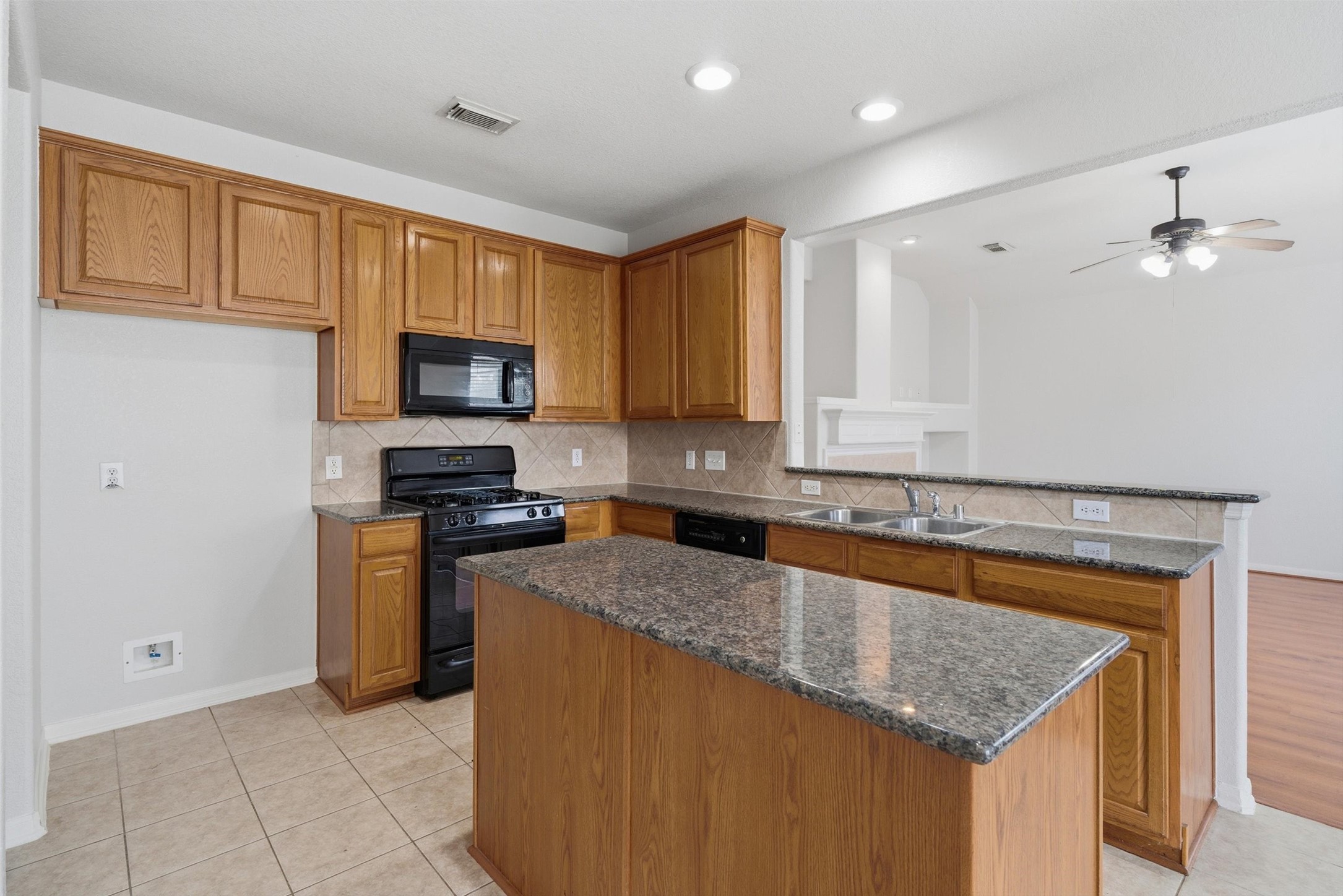 4607 Sebastopol Drive Pearland, TX 77584 - Photo 10 of 26 a kitchen with granite countertop a sink a counter top space appliances and cabinets