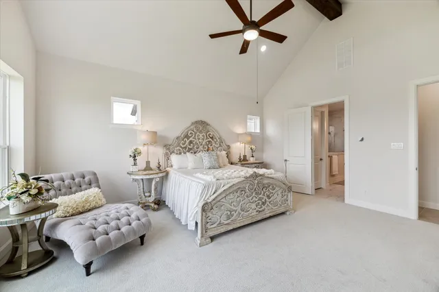 a bathroom with a double vanity sink a toilet a mirror and shower