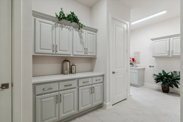 a bedroom with a bed lamp and a large window
