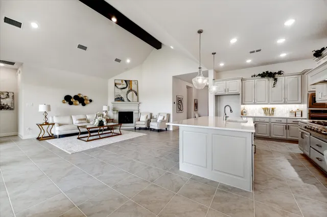 a dining room with furniture and chandelier