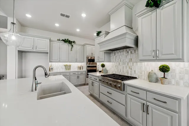 a view of a kitchen with a sink and dishwasher cabinets