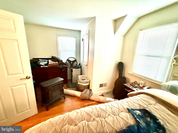 a bedroom with furniture and wooden floor
