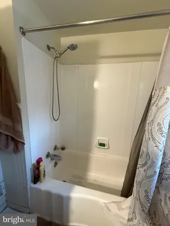 a bathroom with a shower and a shower