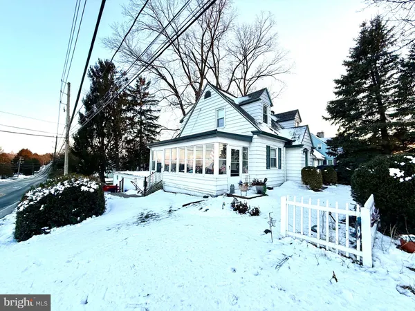 a view of a yard with a house covered in snow