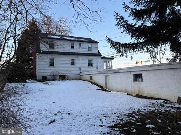 a view of a house with a snow in the yard