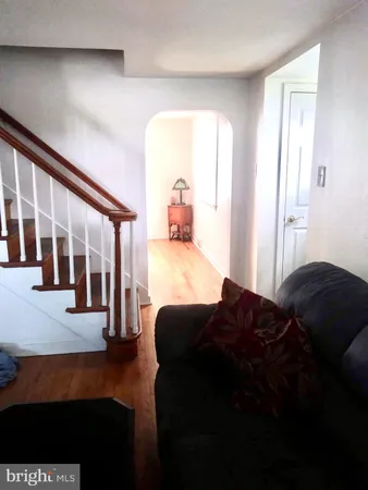 a living room with a bed furniture and a large window