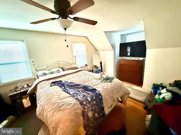 a bedroom with a bed and a television
