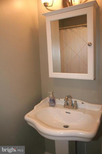 7200 Racepoint Way Alexandria, VA 22315 - Photo 17 of 29 New Pedestal sink, cabinet, and lighting
