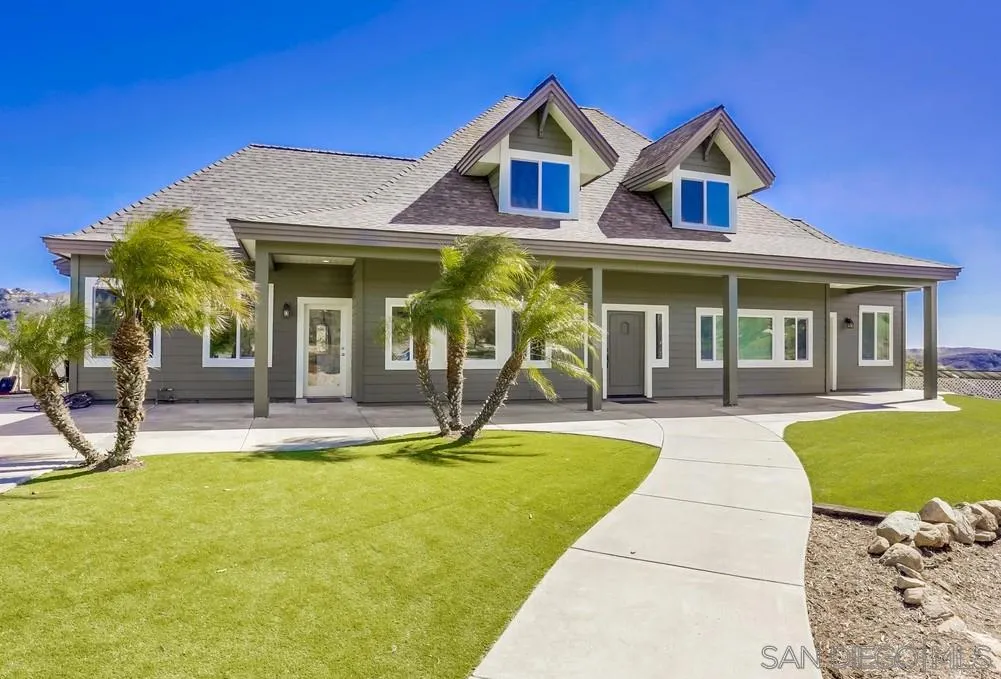 a front view of a house with swimming pool having outdoor seating
