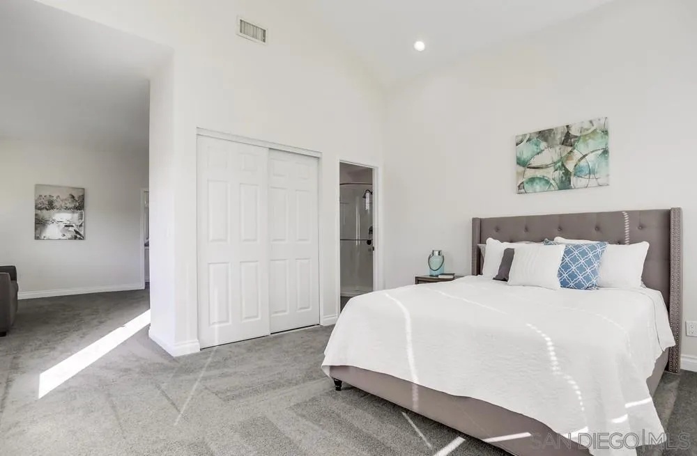 39431 American Road Fallbrook, CA 92028 - Photo 24 of 62 a spacious bedroom with a bed and a painting on the wall