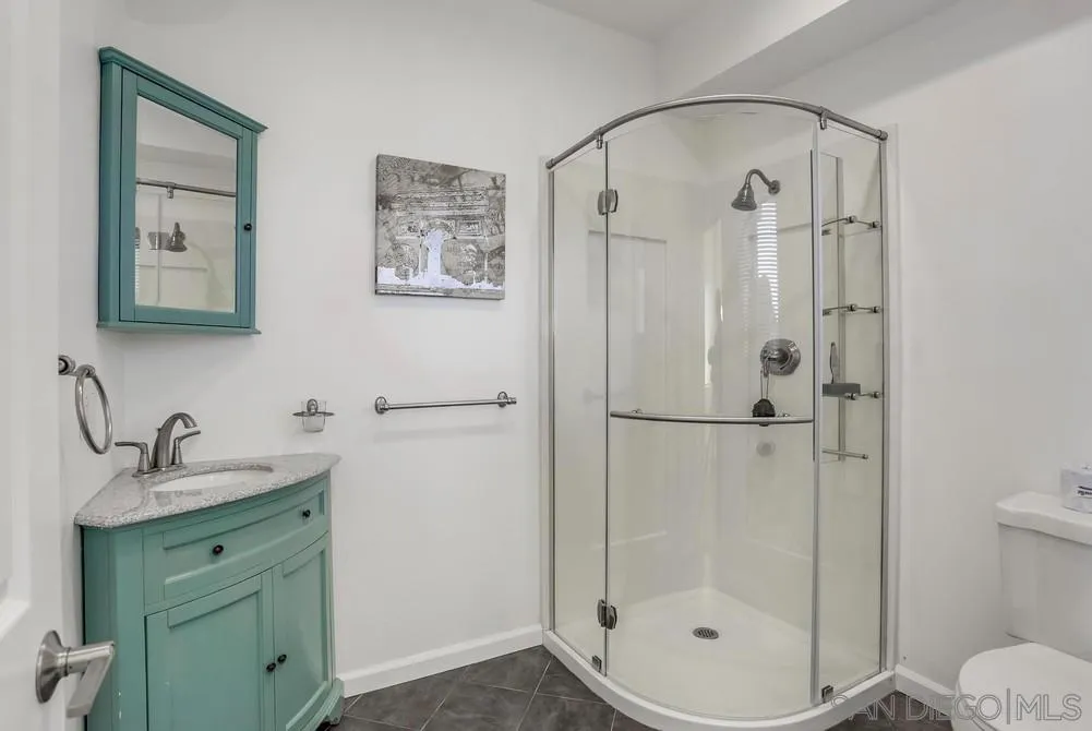 39431 American Road Fallbrook, CA 92028 - Photo 26 of 62 a bathroom with a shower sink and mirror